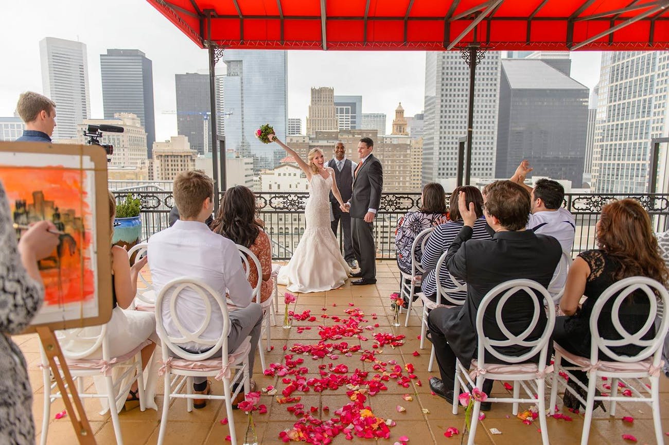 Wedding ceremony on the Rooftop of Hotel Icon In Houston With Guests and Couple Walking Down Aisle | PartySlate