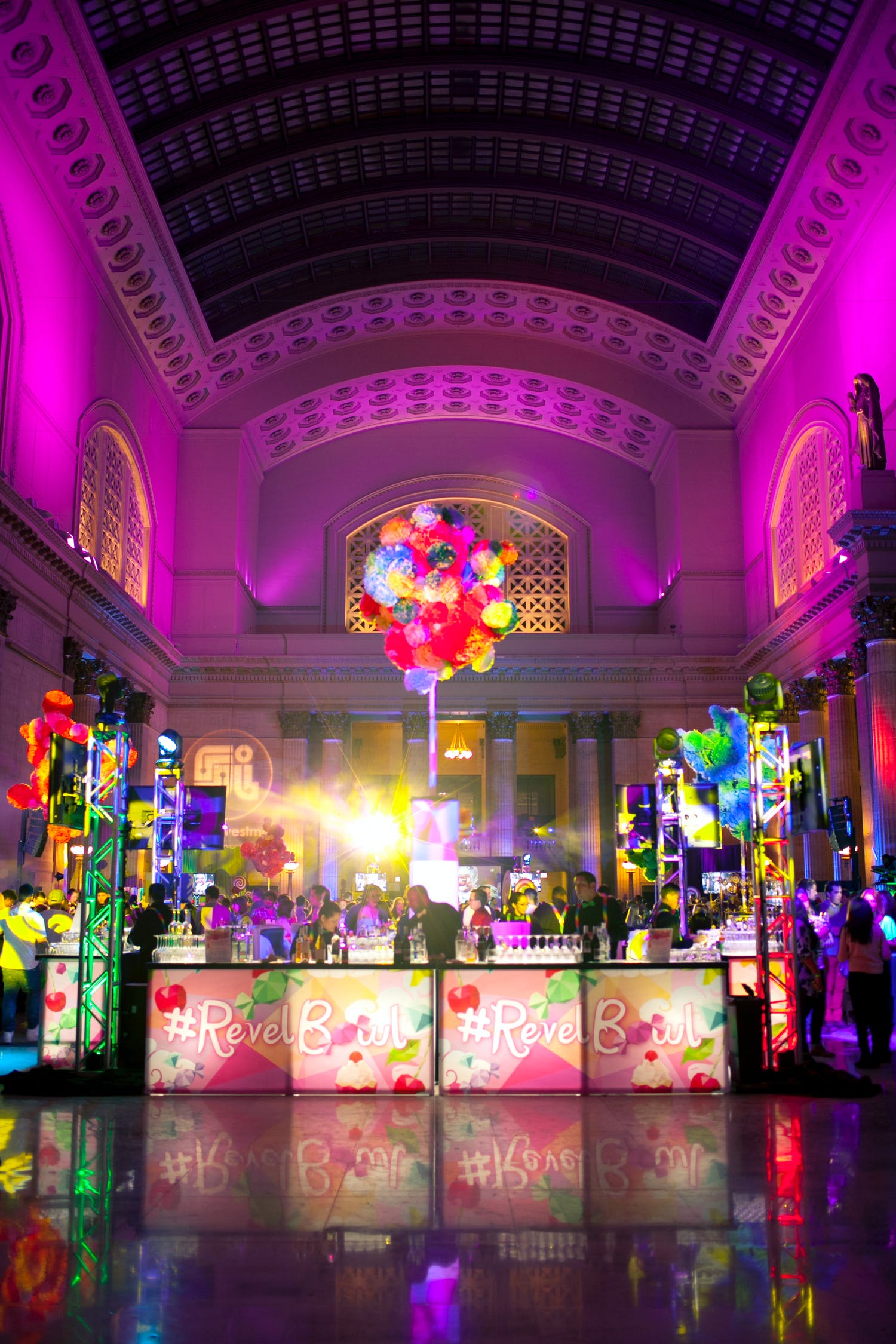 Candyland themed hospitality party with bar area with floating cotton candy installation | PartySlate
