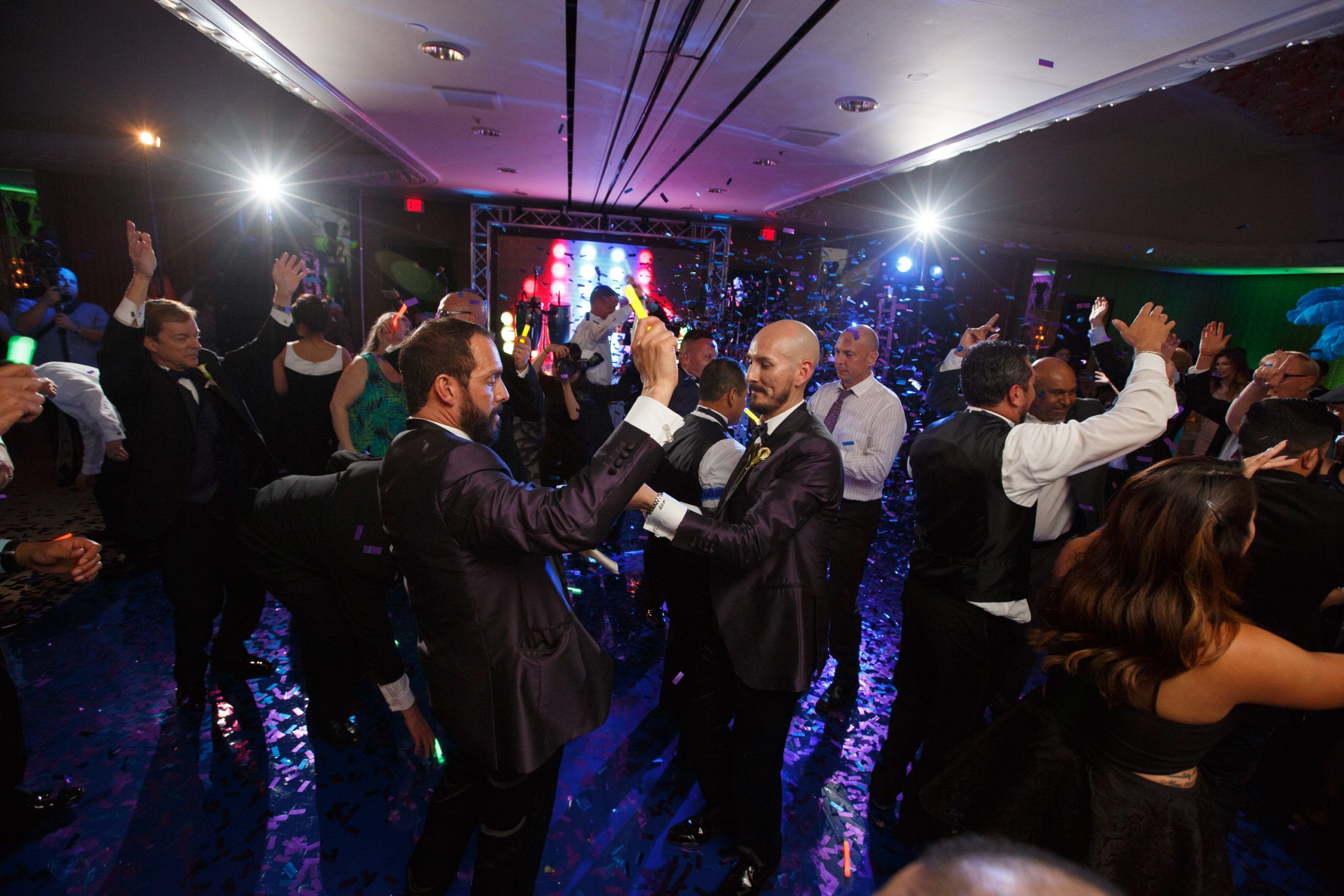 Warm and romantic Wedding At Four Seasons Hotel Houston With Grooms on the Dance Floor with Confetti | PartySlate