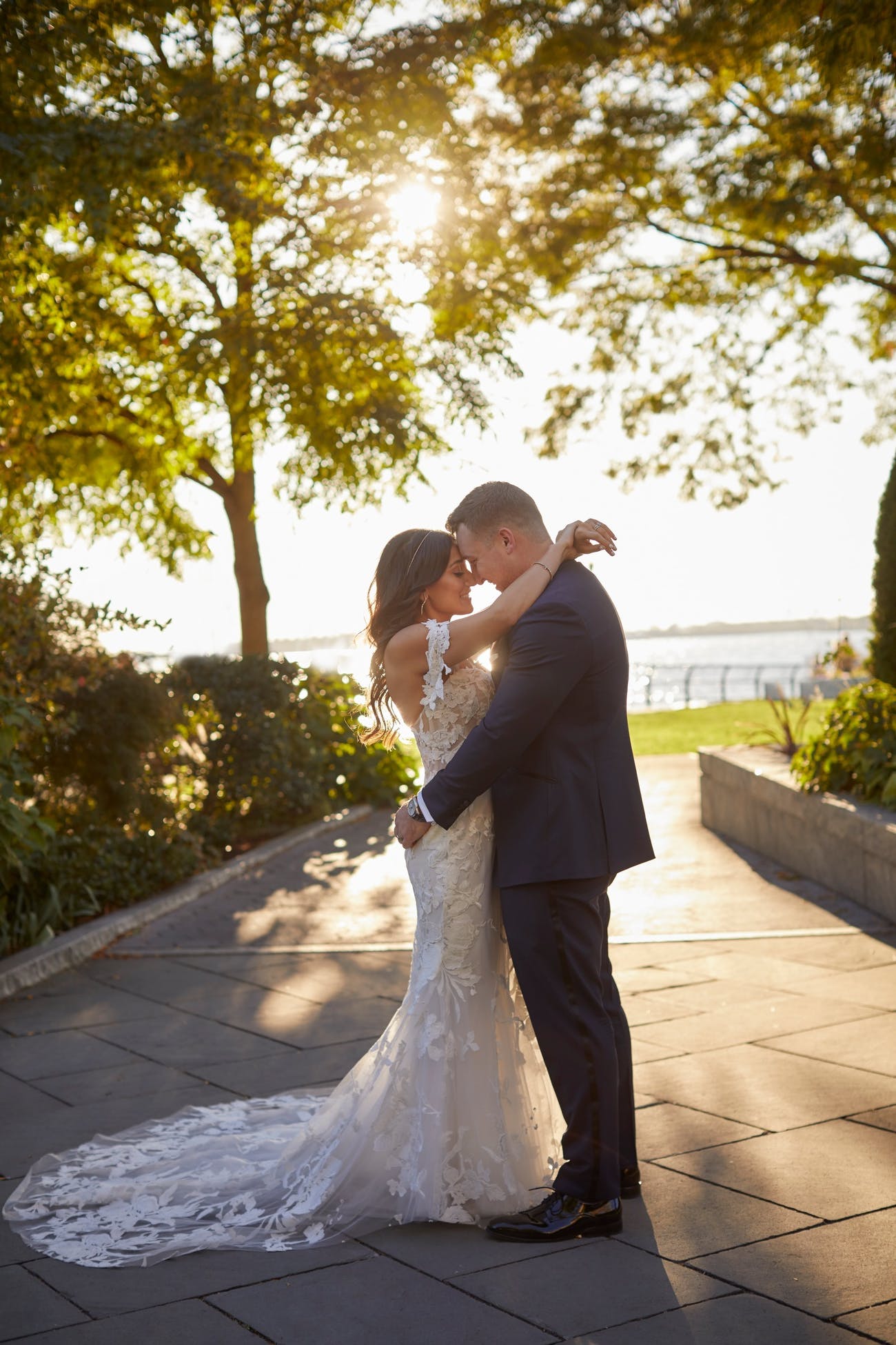Bride and groom posing for outdoor photos on their wedding day