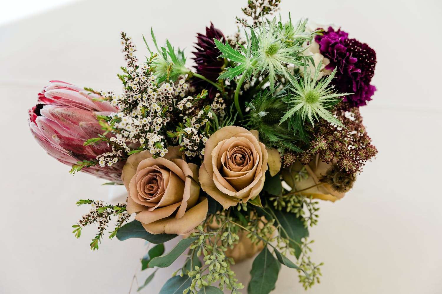 Romantic beach wedding bouquet in gold and burgundy | PartySlate