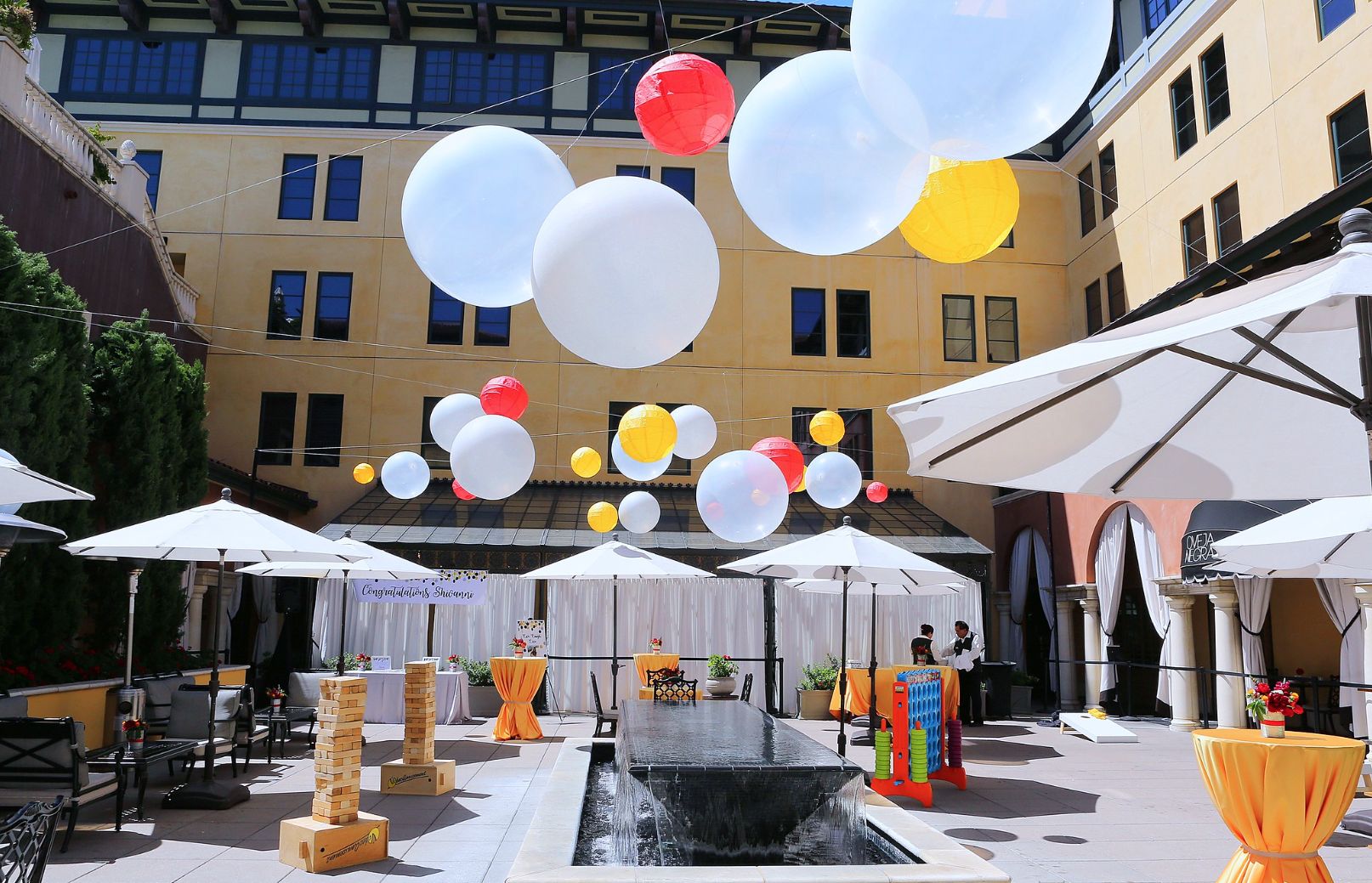 outdoor graduation party with balloons and yard games | PartySlate