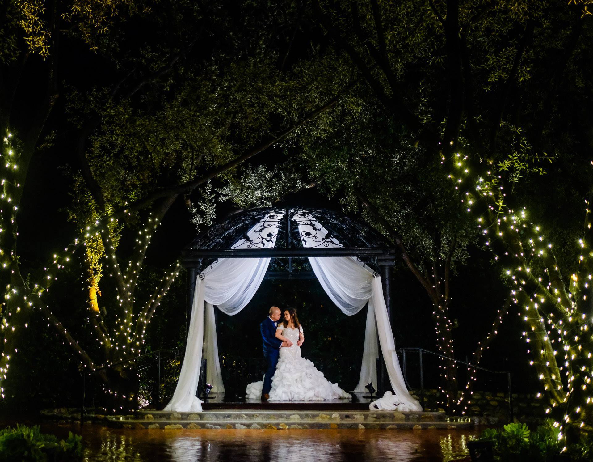 Nighttime wedding with white drapery at Padua Hills Theatre | PartySlate