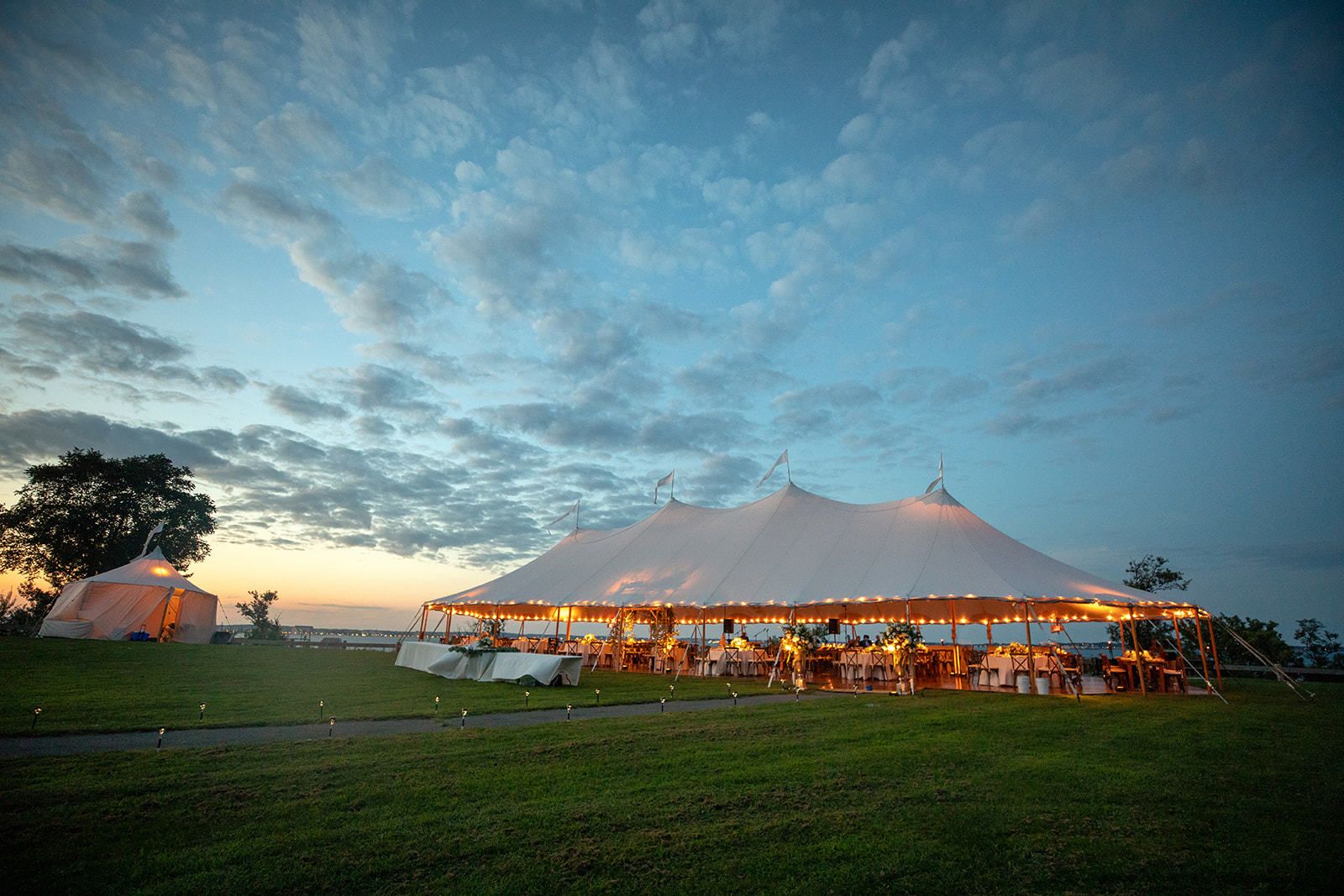 Boston waterfront pole tented wedding at sunset | PartySlate