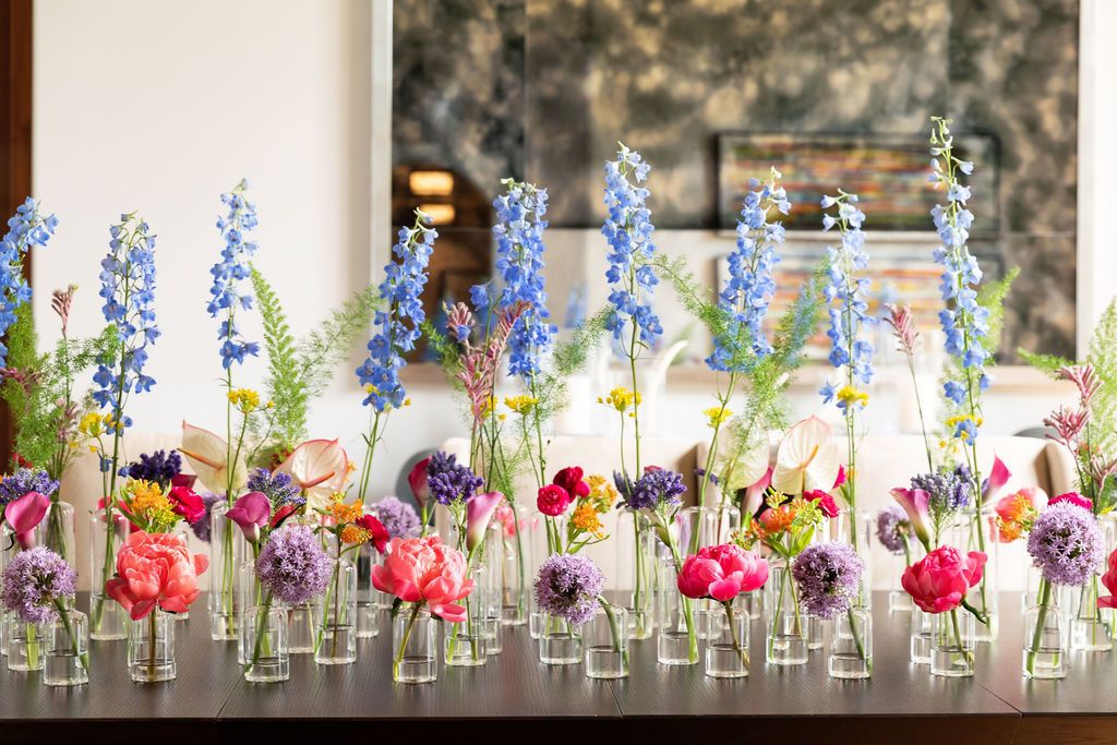 colorful floral centerpiece on a table for a graduation party | PartySlate