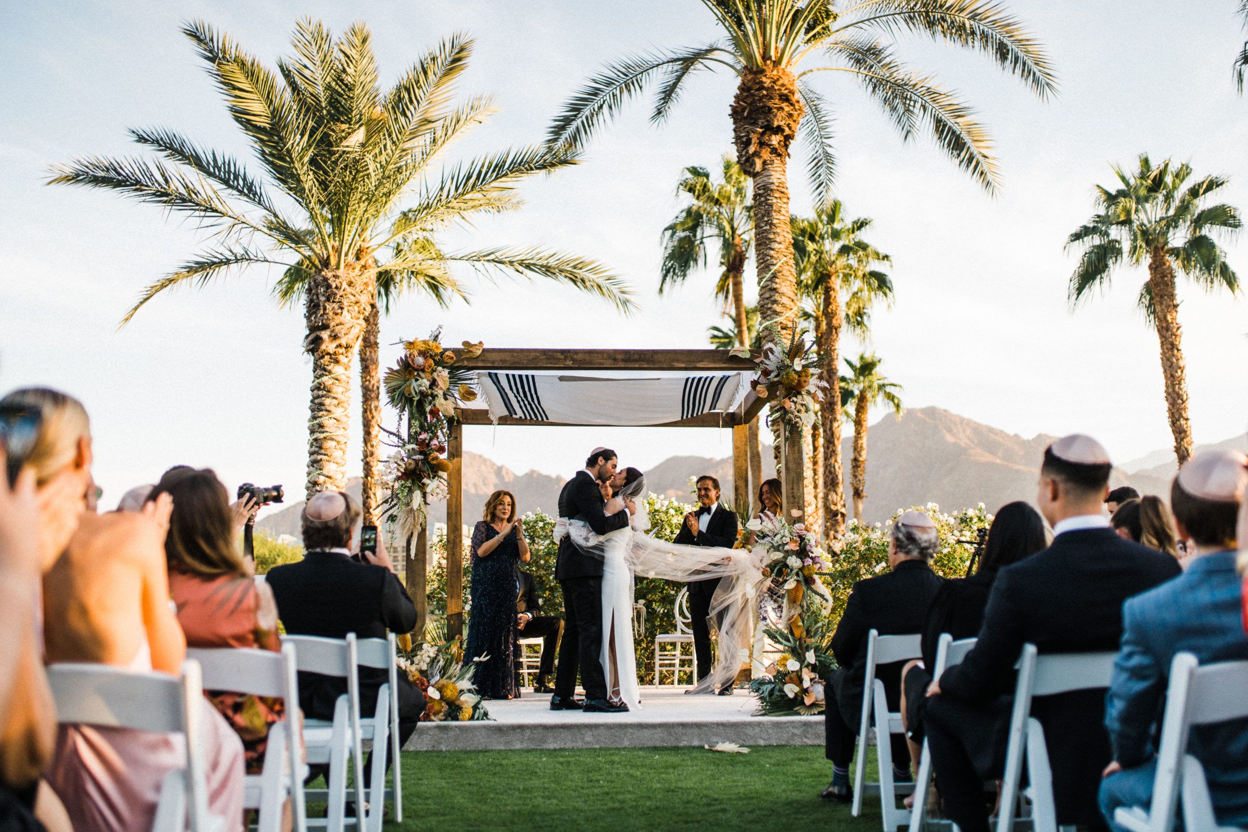 Jewish wedding ceremony with palm trees at Indian Wells Golf Resort | PartySlate