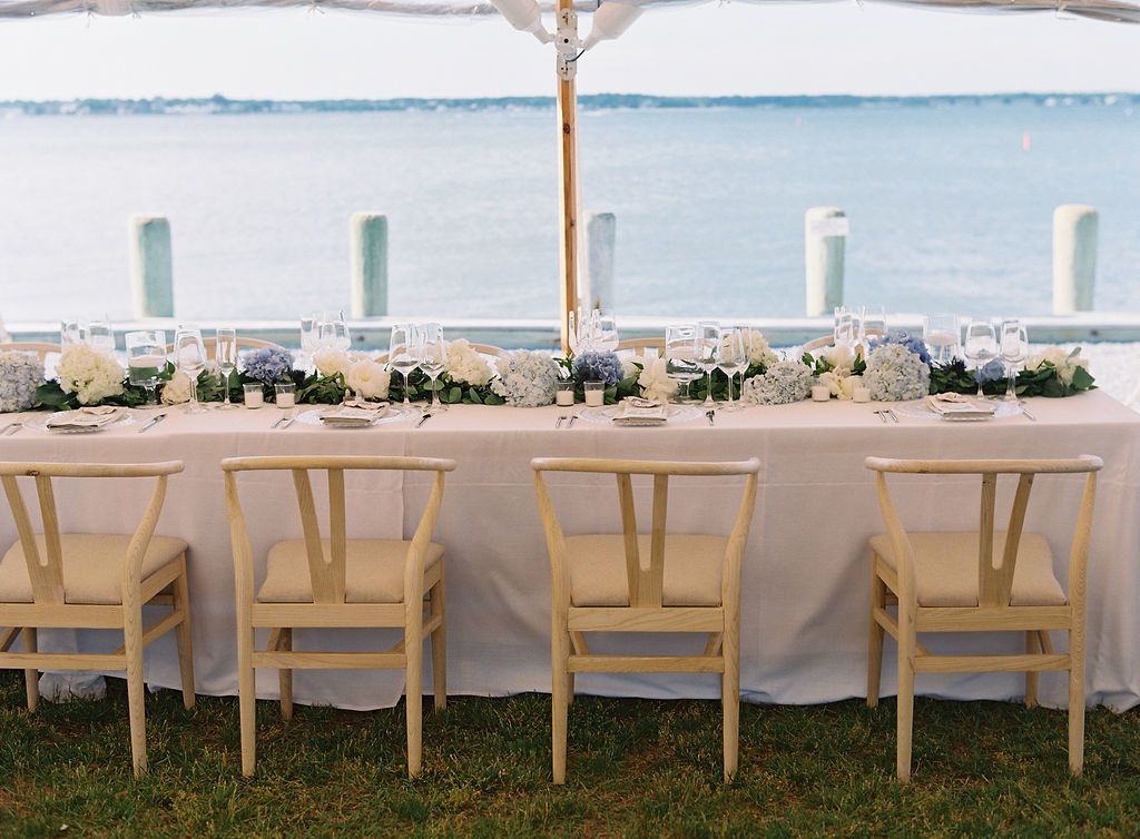 Preppy blue and white tented wedding reception on ocean | PartySlate