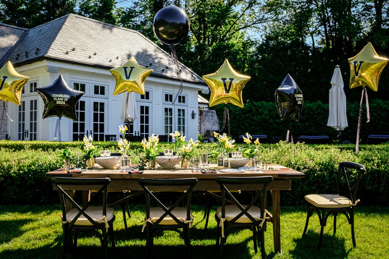 graduation party with gold and black balloons and accents on table | PartySlate