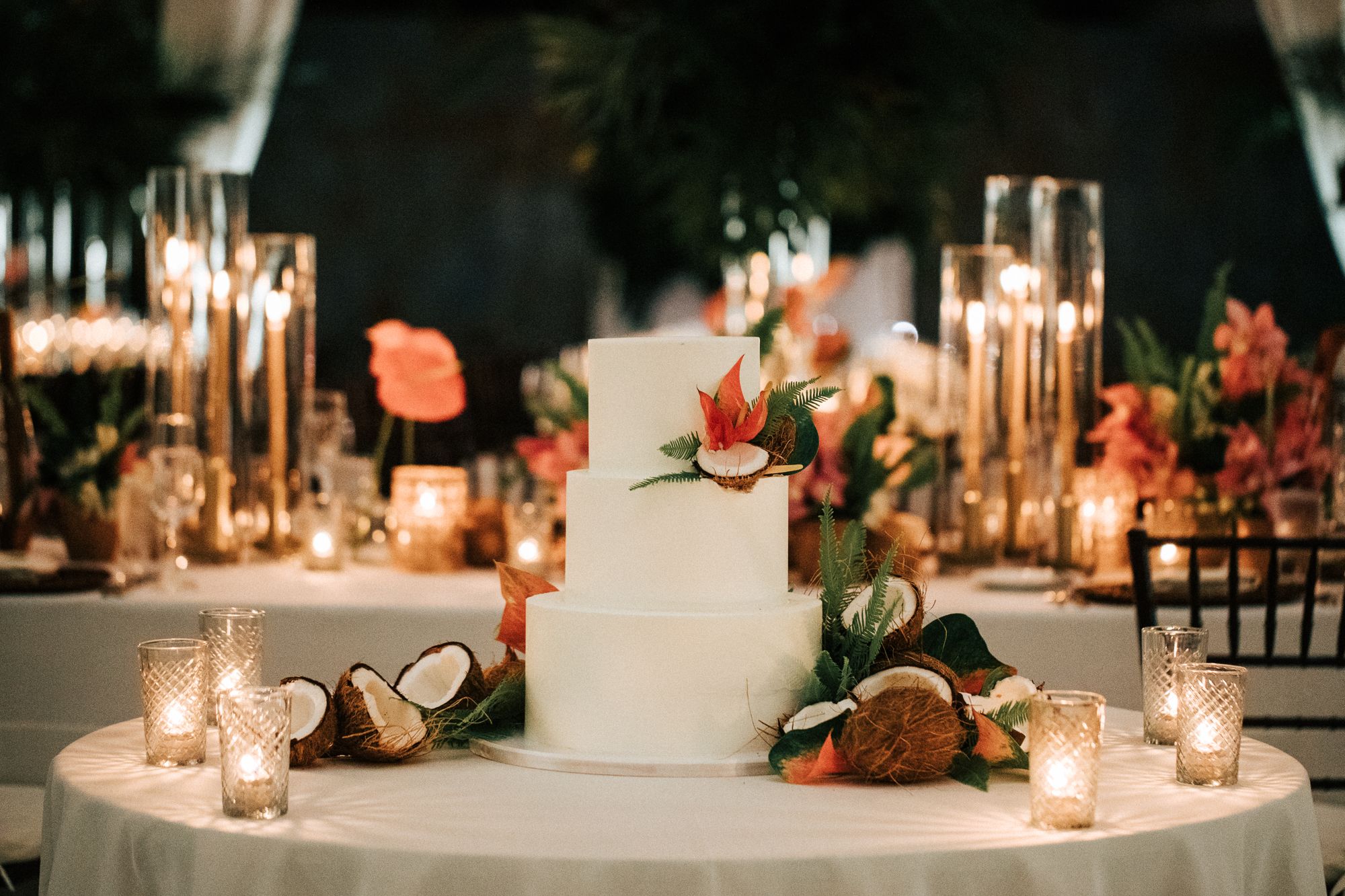 White wedding cake with coconut and orange floral decorations | PartySlate