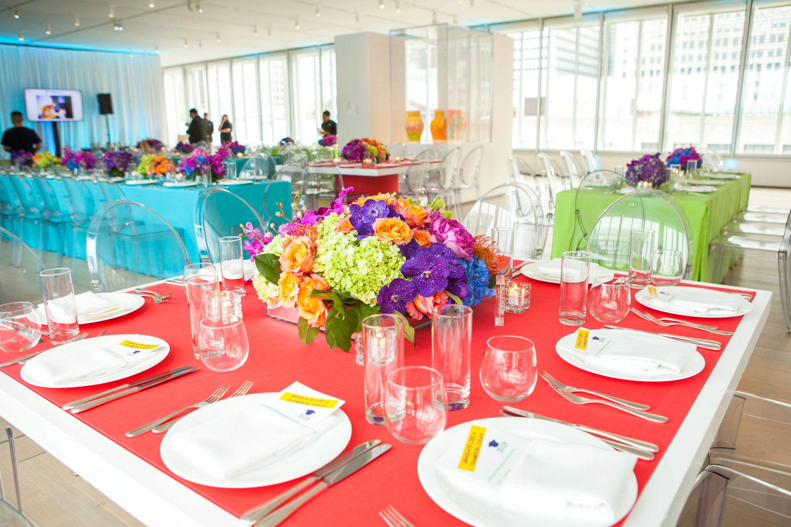 colorful floral centerpiece on a table for a graduation party | PartySlate