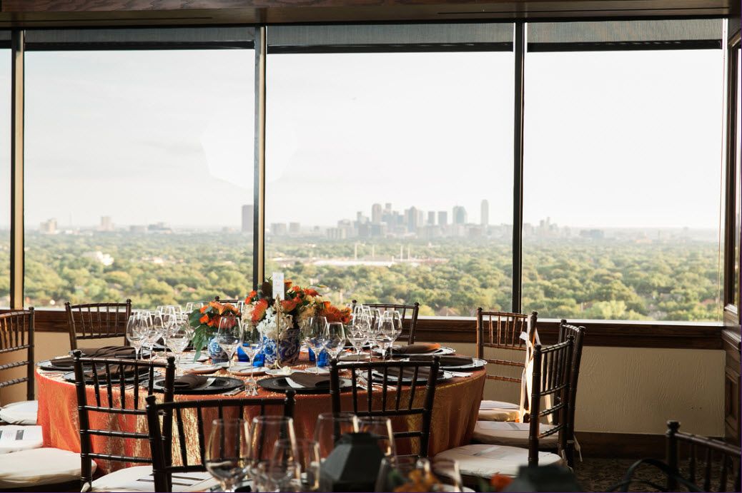 Private dining restaurants in Dallas main dinning room with chairs and tables set with skyline in the background | PartySlate