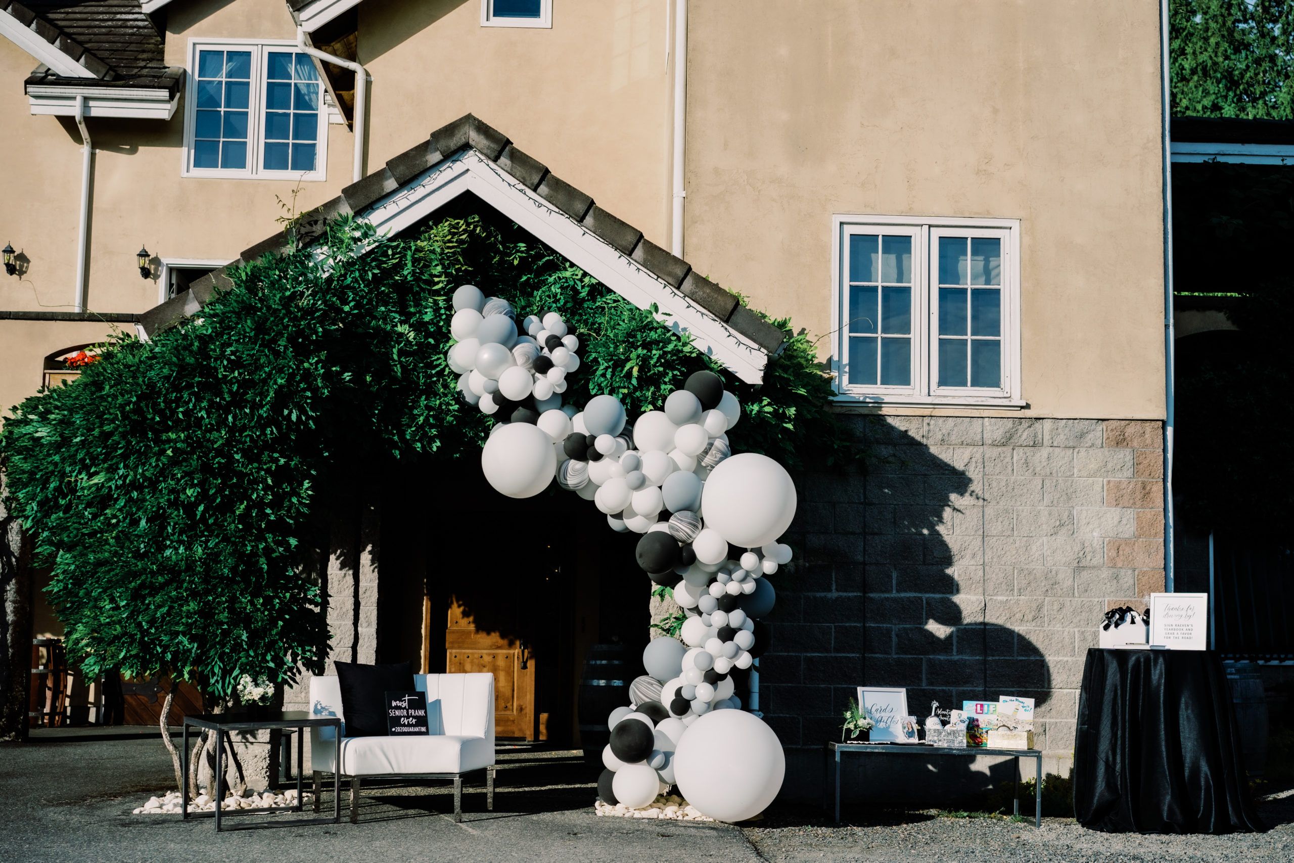 black and white balloon installment on the side of a house | PartySlate