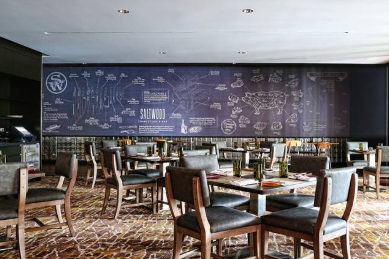 private dining room in atlanta with tables and chair set up in front of a blue accent wall inside restaurant | PartySlate