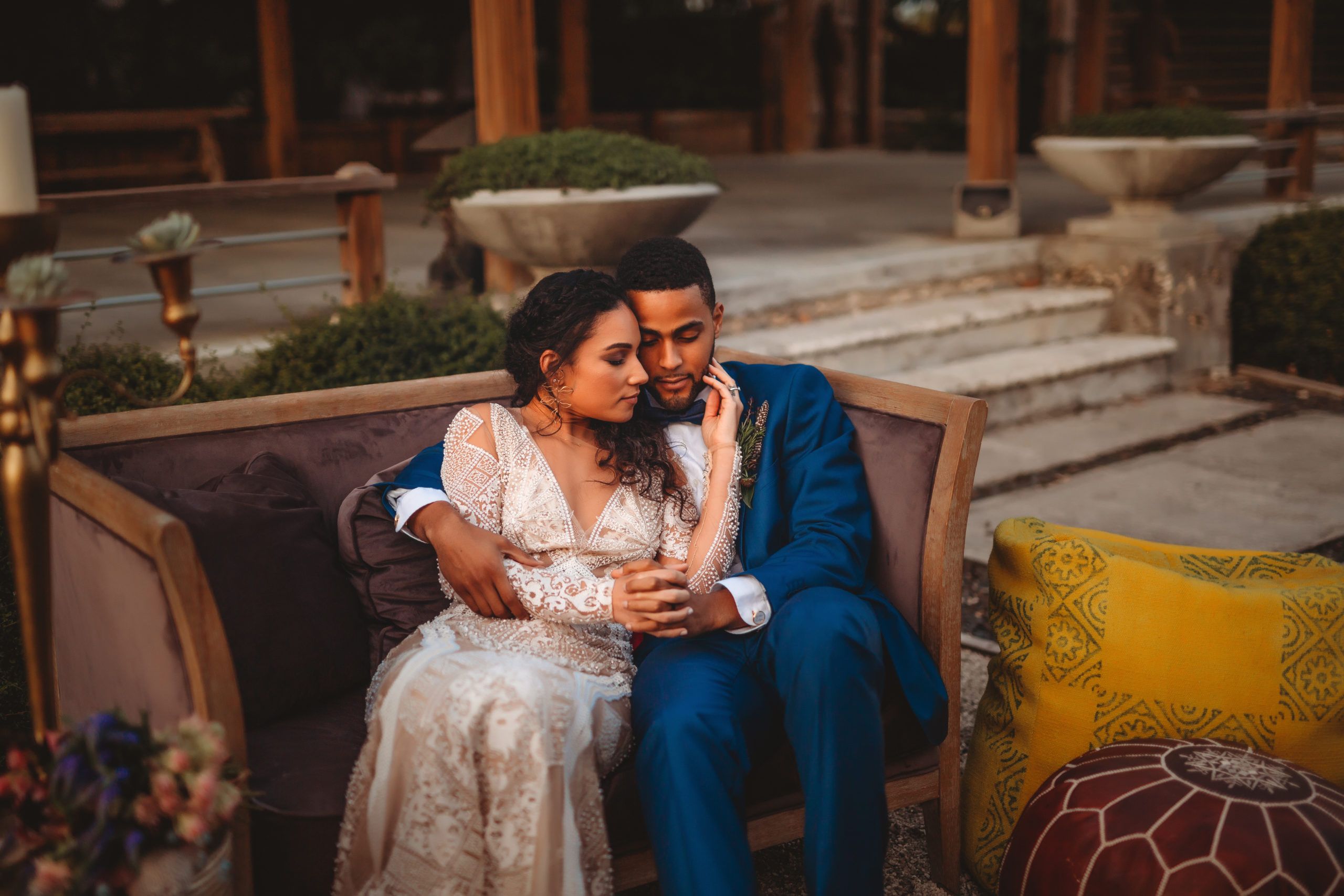 couple hugging in chair at outdoor wedding reception in miami | PartySlate