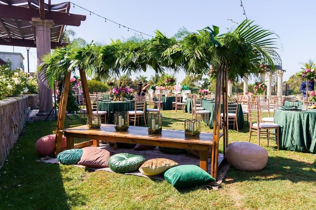 Boho baby shower with elevated palm frond centerpieces | PartySlate
