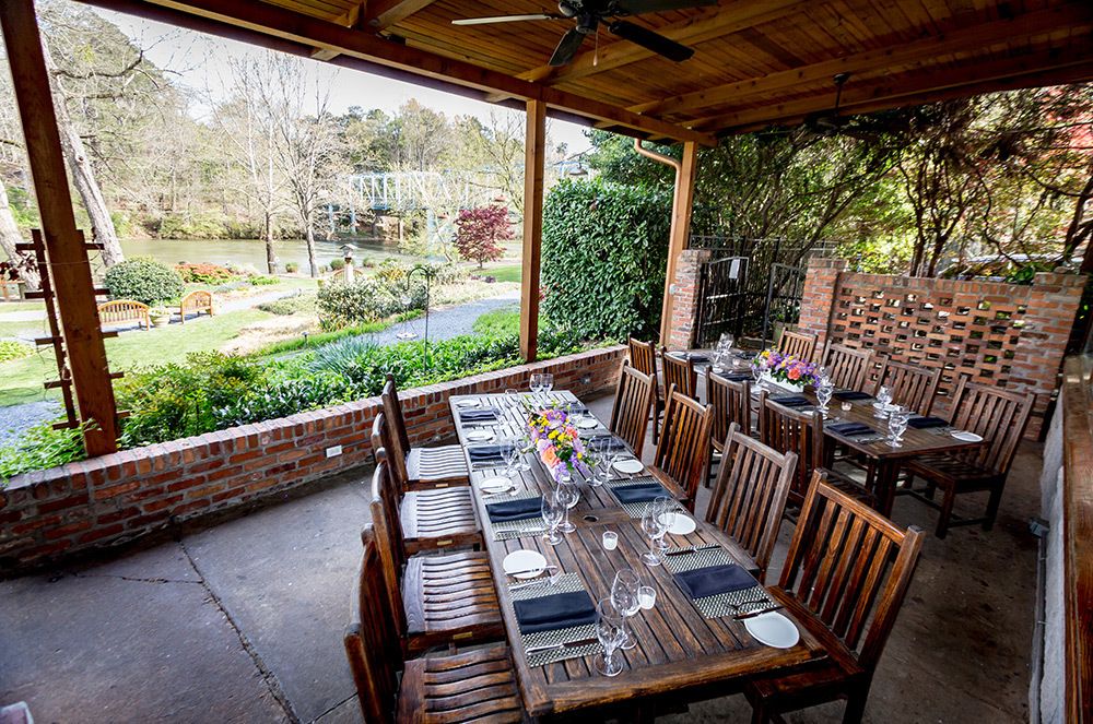 outdoor patio privatae dining room in atlanta woth river and natural scenery in the back | PartySlate