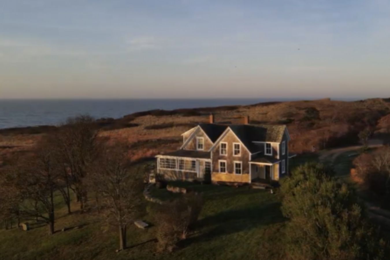 Aquinnah Vanderhoop Homestead on the coast during teh fall with fall foliage | PartySlate
