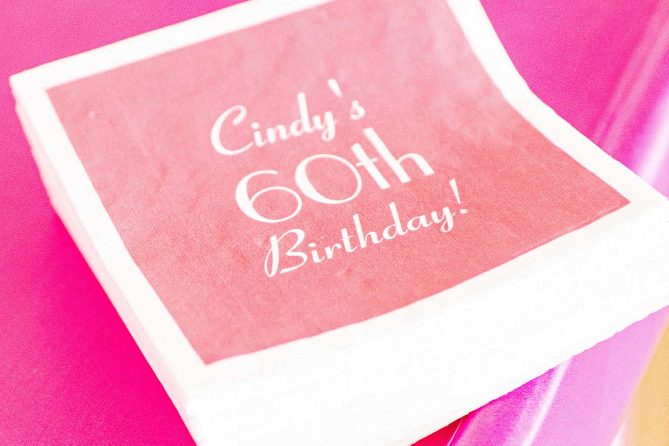 personalized 60th birthday napkins in pink | PartySlate