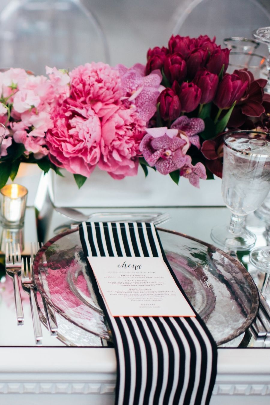 Black and white tablescape with bright pink flowers at wedding planned by AE Events | PartySlate