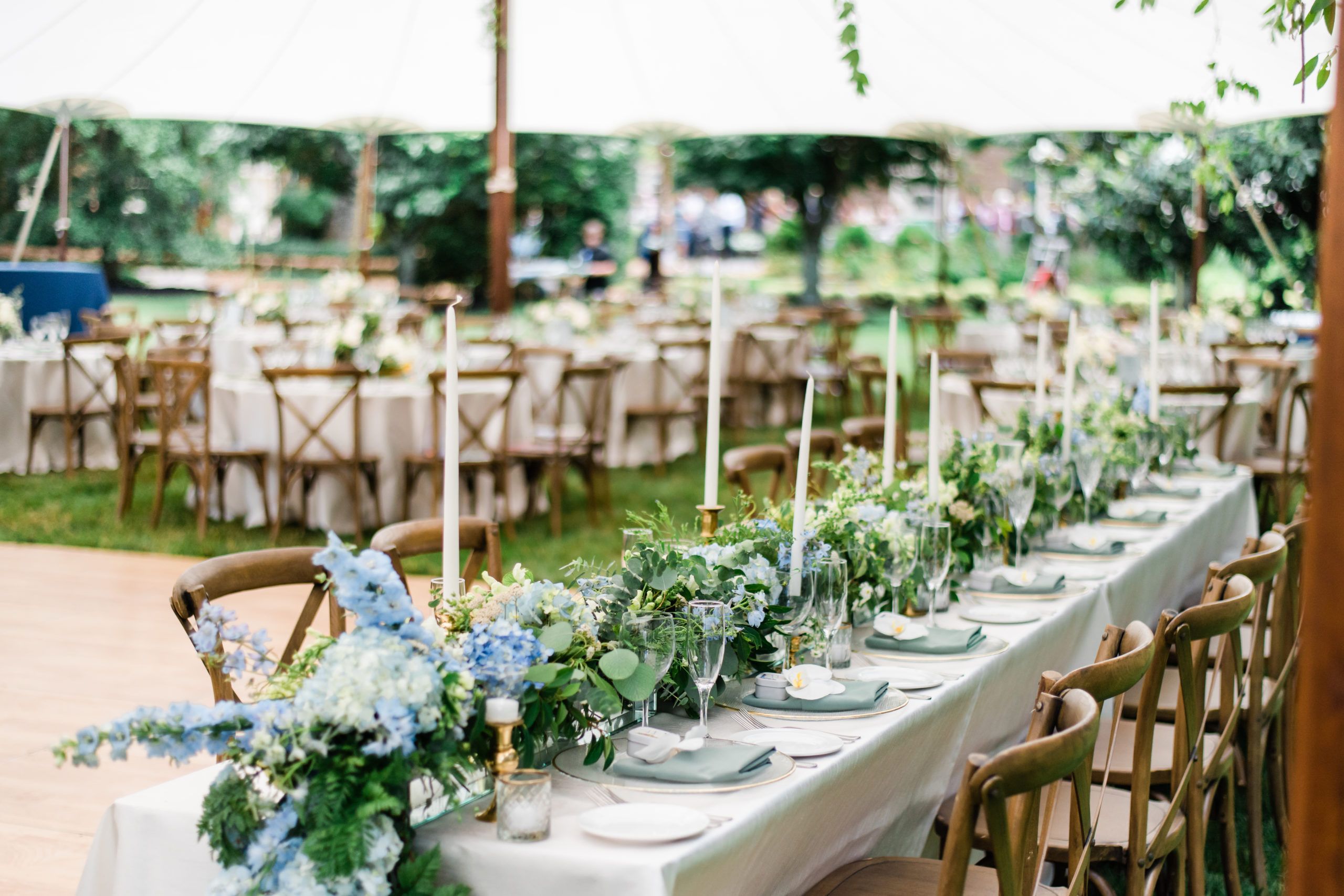 Outdoor summer wedding with blue floral centerpieces | PartySlate