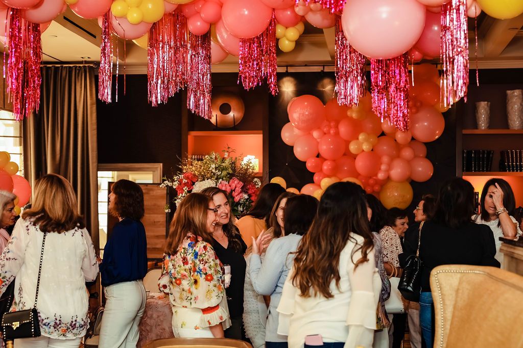 indoor pink and yellow balloon installation at 60th birthday party | PartySlate