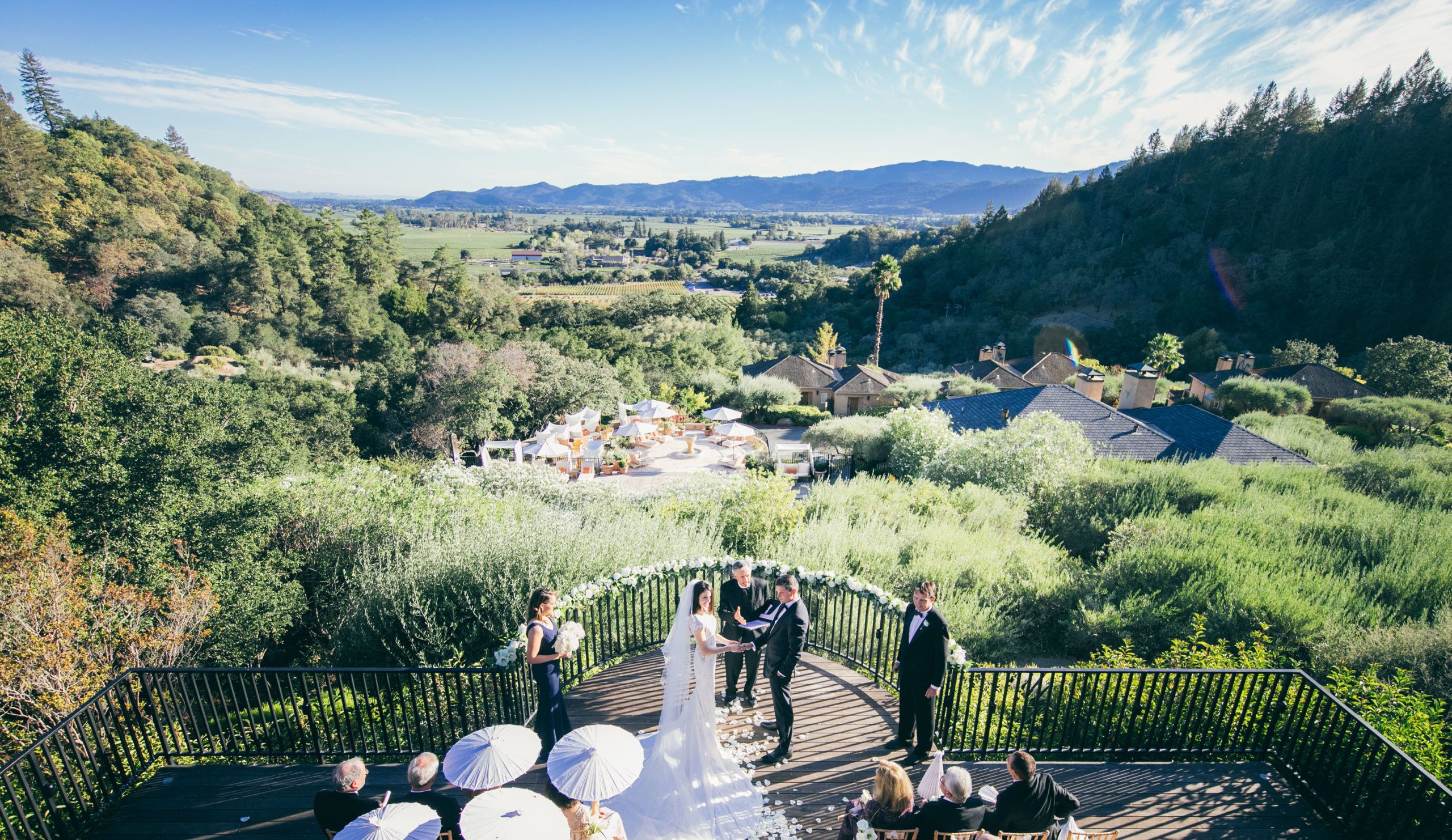 modern outdoor wedding in northern california wine country with green grass and views of the hills with couple standing at the alter | PartySlate