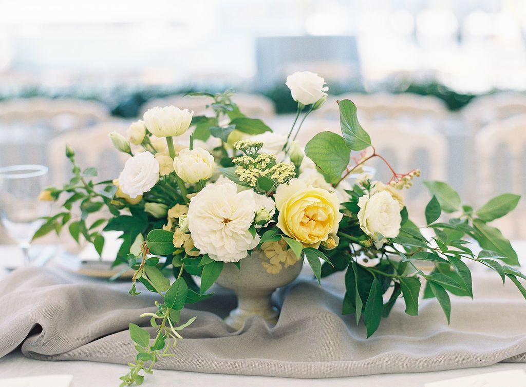 Summer wedding centerpiece with white and yellow flowers | PartySlate