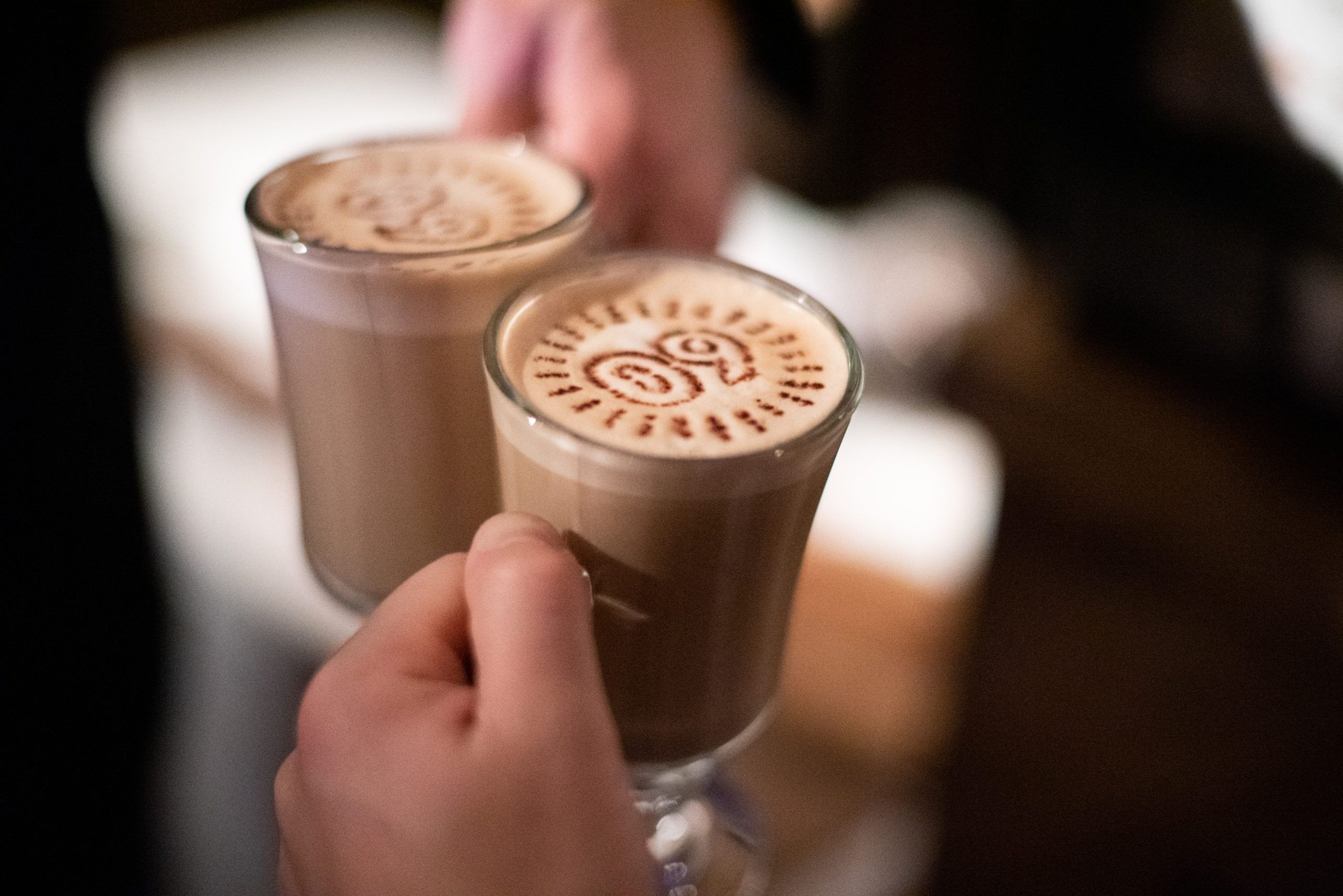 lattes in glass cups with personalized latte art on top | PartySlate