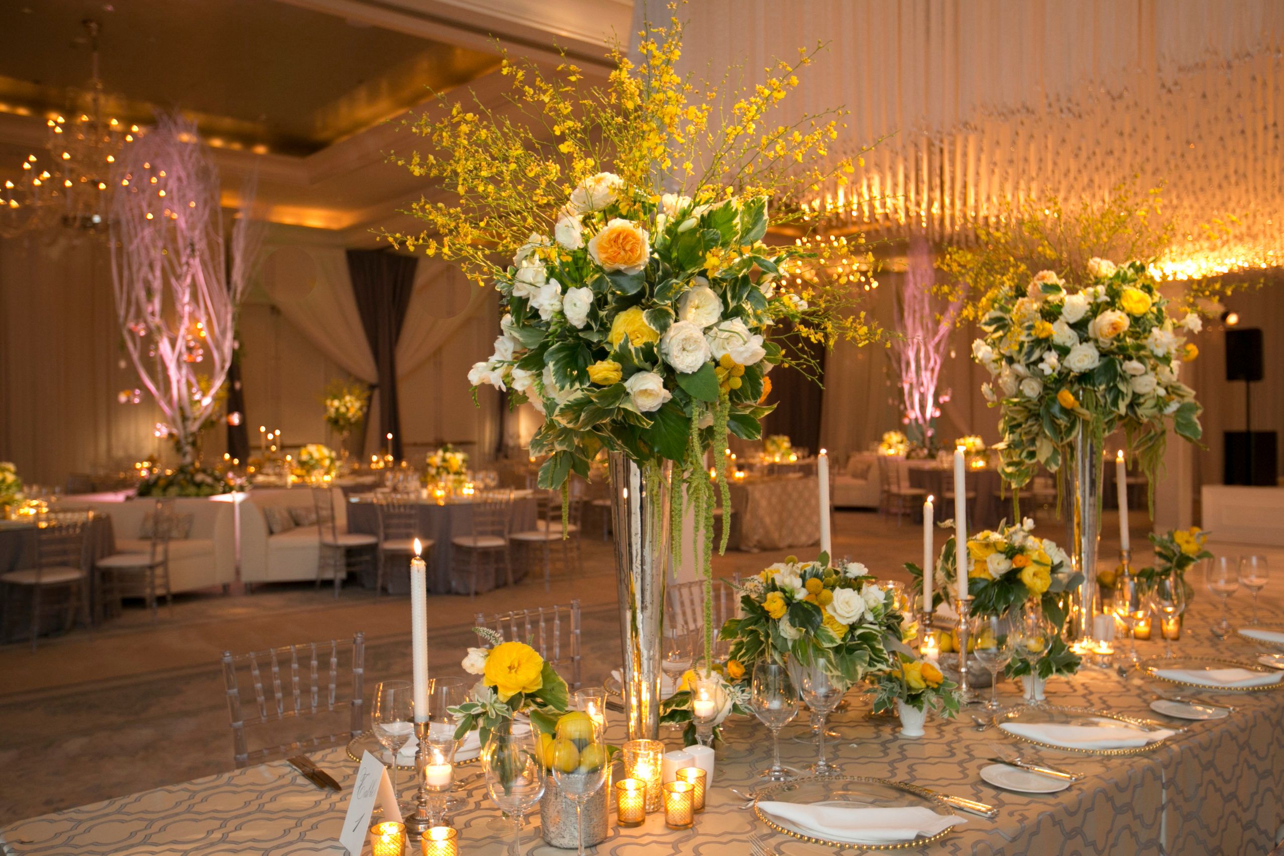 Summer wedding with bright yellow flower centerpieces | PartySlate