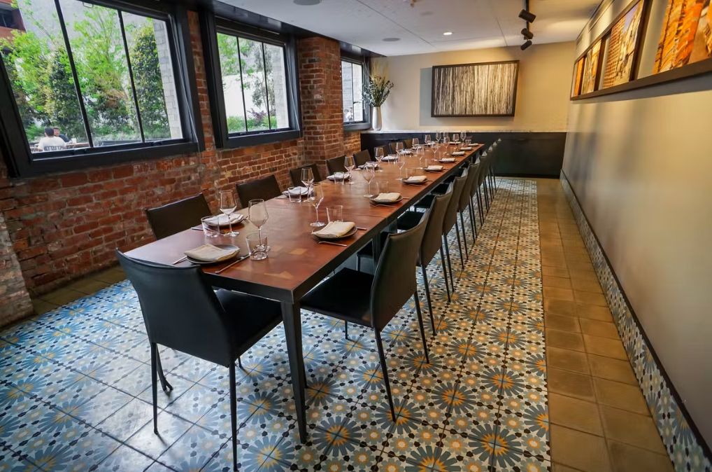 private dining room at Mourad with decorative tile flooring and long table in the center of the room | PartySlate