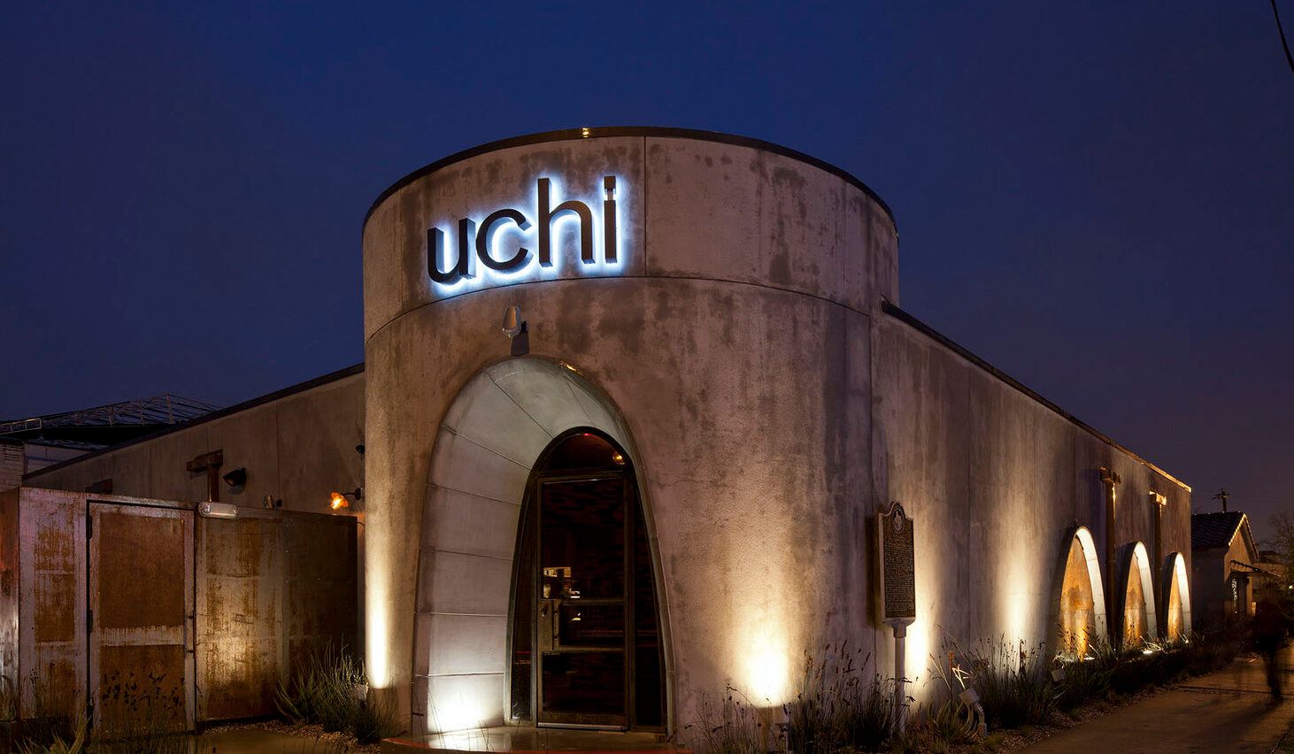 Uchi Houston exterior of restaurant at night with lights on the walls | PartySlate