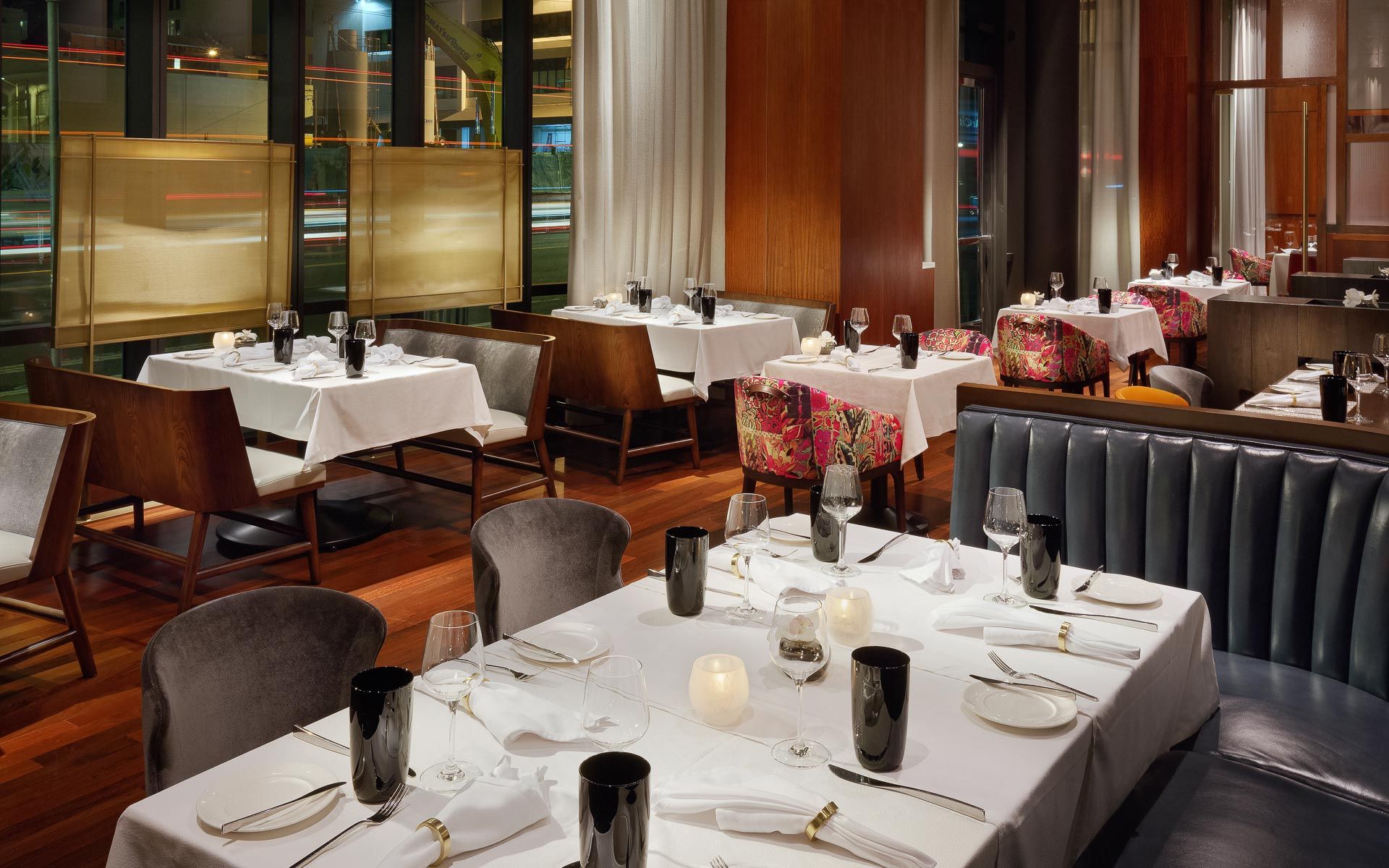 Luce at InterContinental San Francisco main dining space with black leather booth seats and tables set | PartySlate