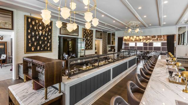 interior view of State of Grace restaurant with private dining room in Houston with decorative lighting and bar area | PartySlate