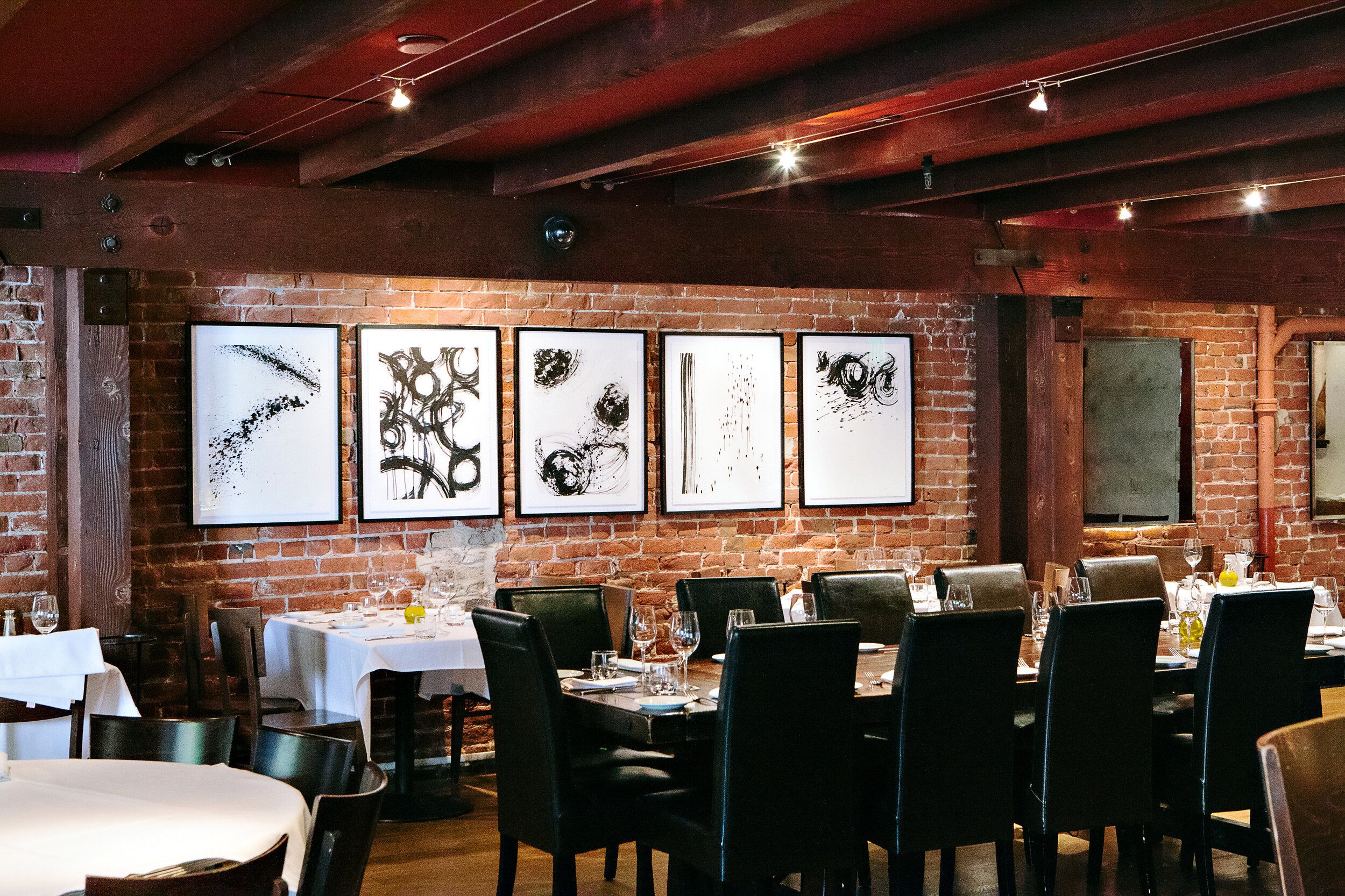 Piperade private dining space with black and white artwork and long tables | PartySlate