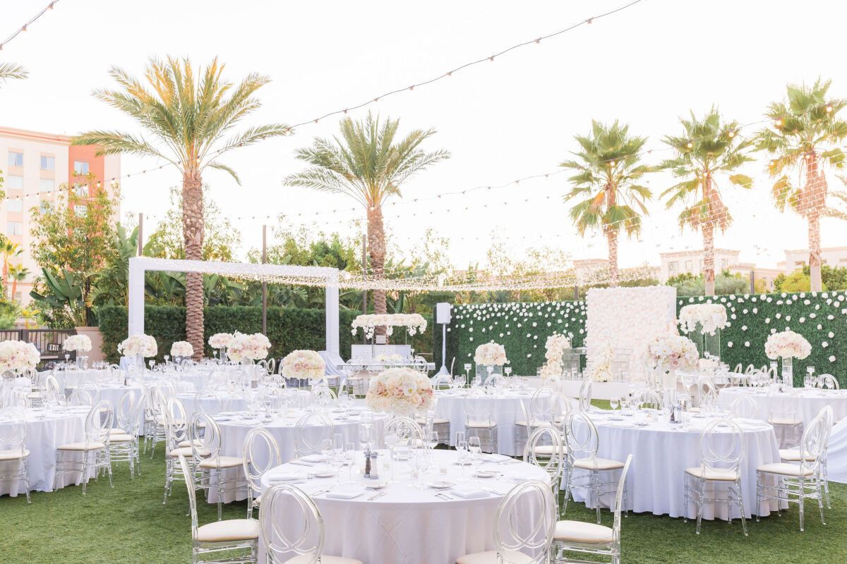 Carole & Joseph's Marriott Irvine Spectrum outdoor Wedding venue in southern california with string lights | PartySlate