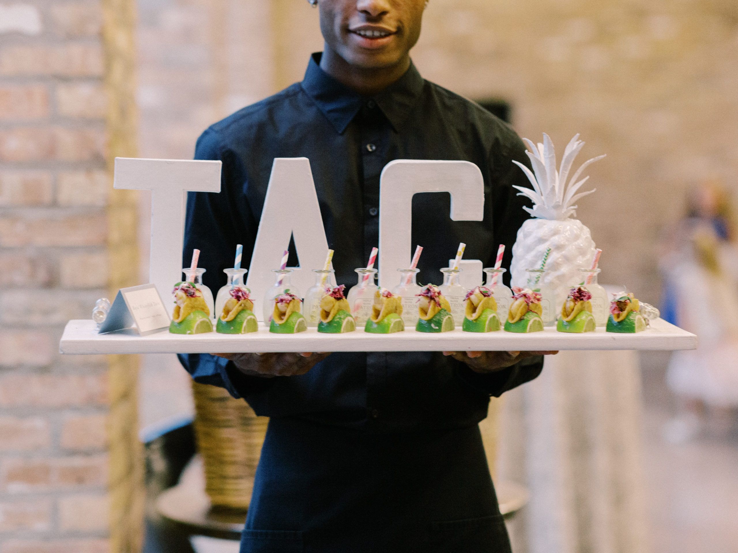 A serving tray with "Taco" signage and miniature tacos.