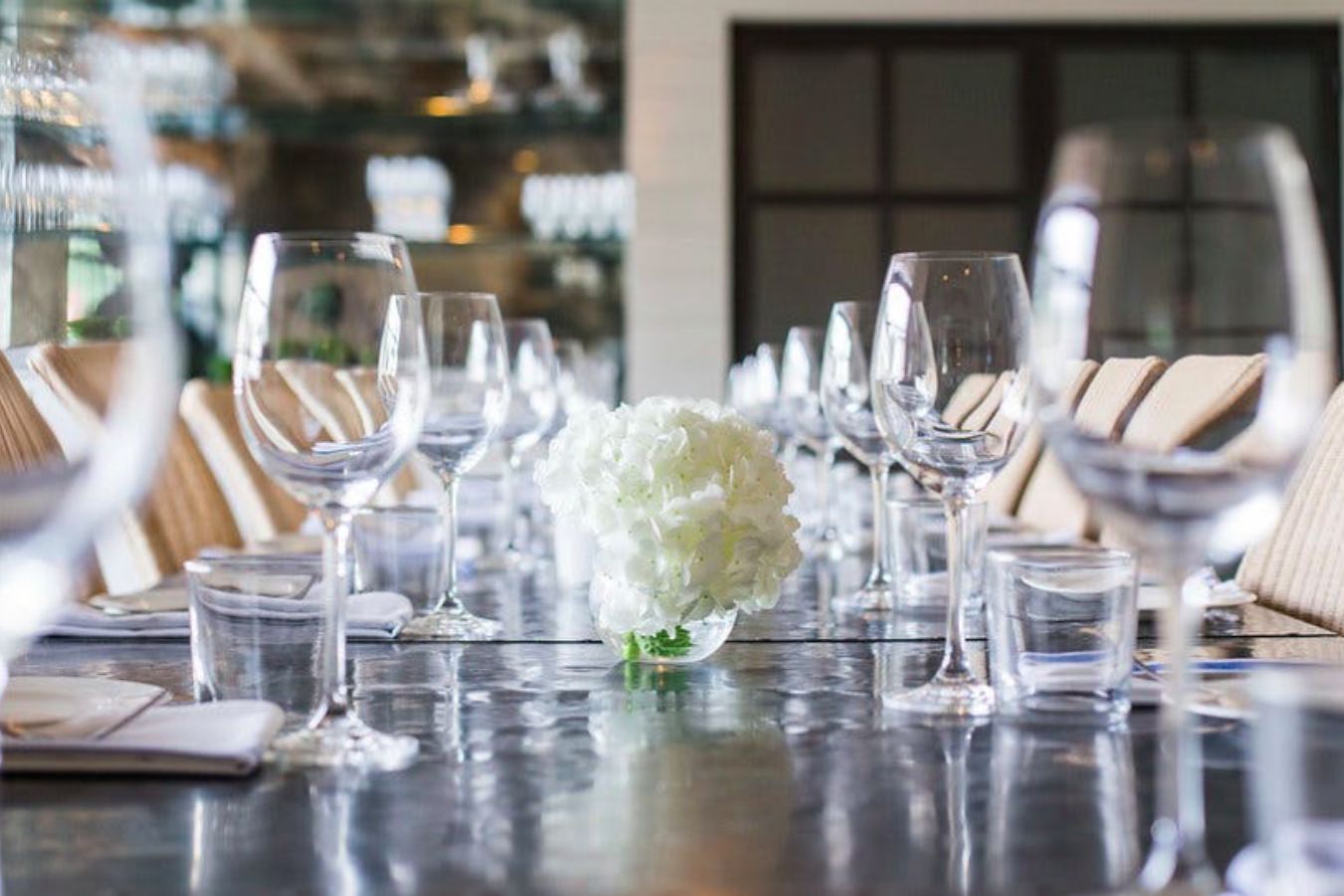 Tablescape with white florals for a private dinner at Tiny Boxwoods in Houston, TX | PartySlate