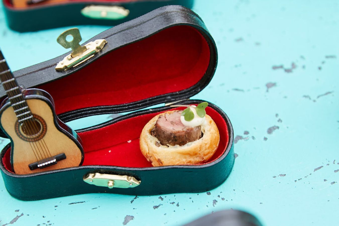 Mini apps served in mini guitars at Jerrypalooza-themed party | PartySlate