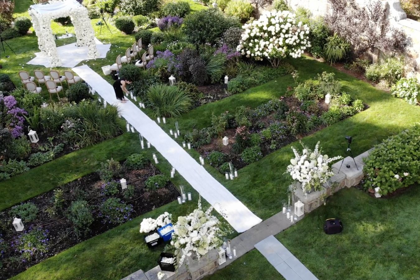 Garden wedding ceremony with white floral chuppah | PartySlate