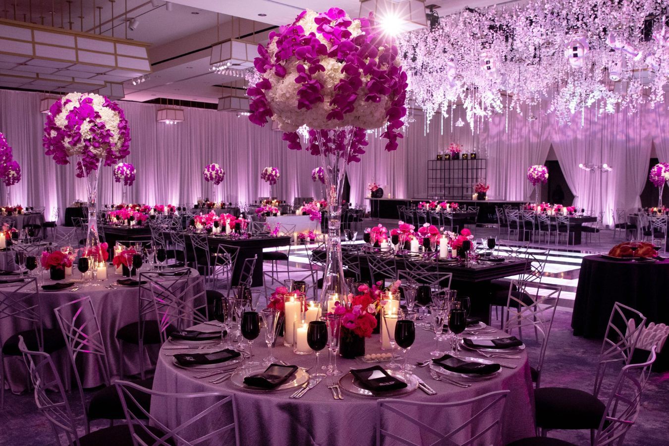 Glamorous tall wedding centerpieces with hot pink orchids | PartySlate