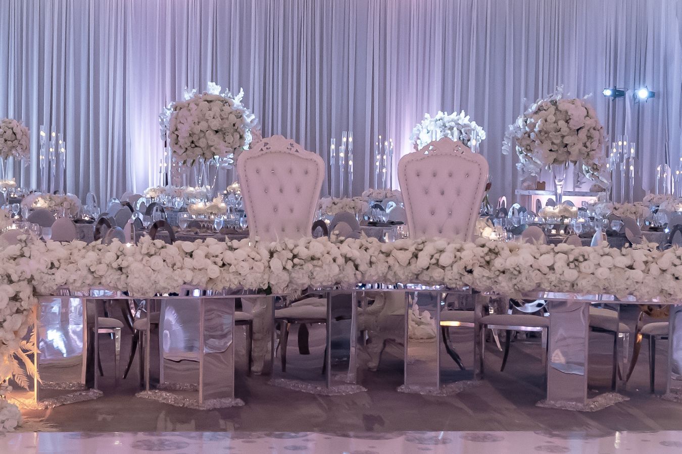 Glamorous white wedding with tall white wedding centerpieces | PartySlate