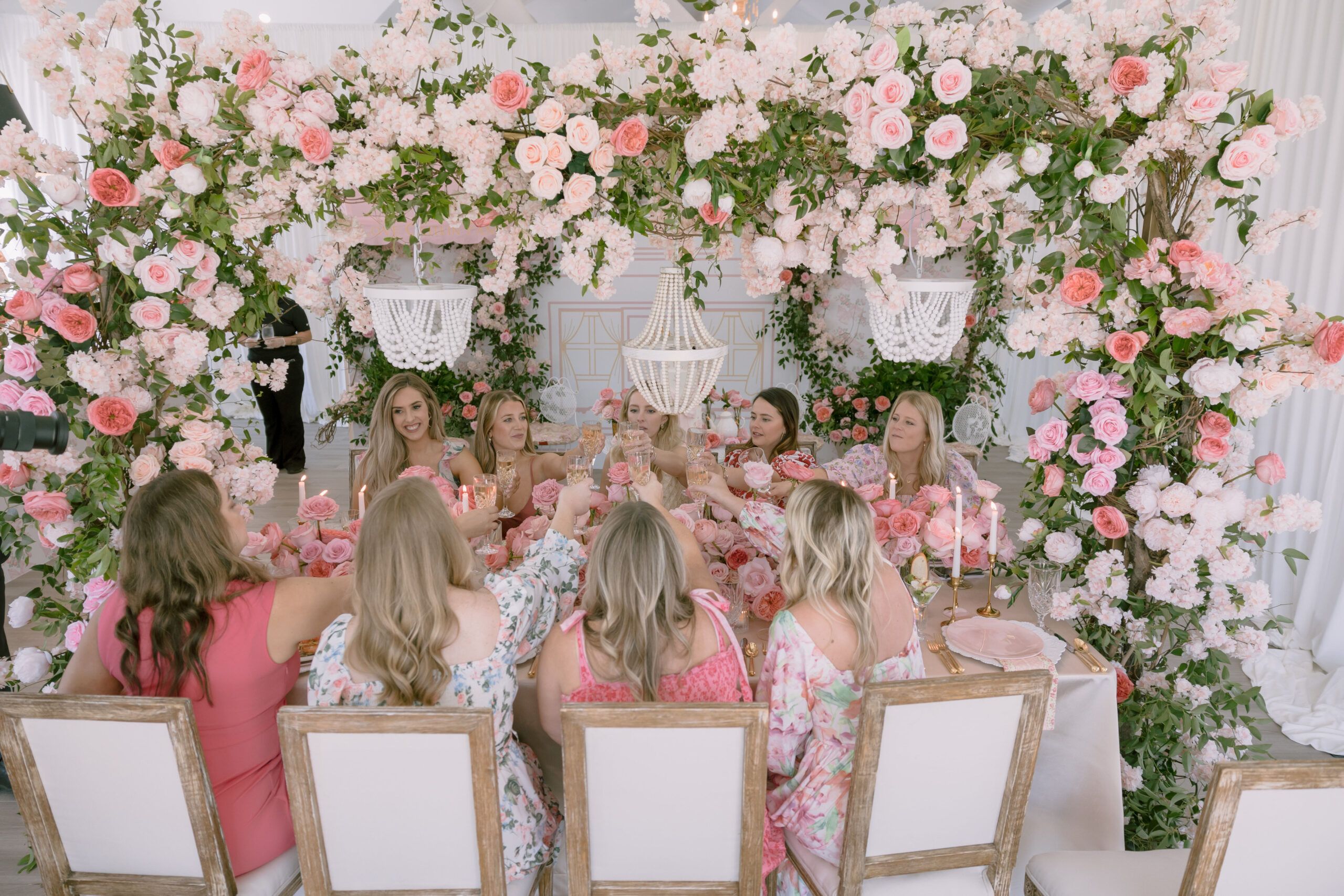 Bridal shower with giant flower wall backdrop in pink and gold, elegant party setting