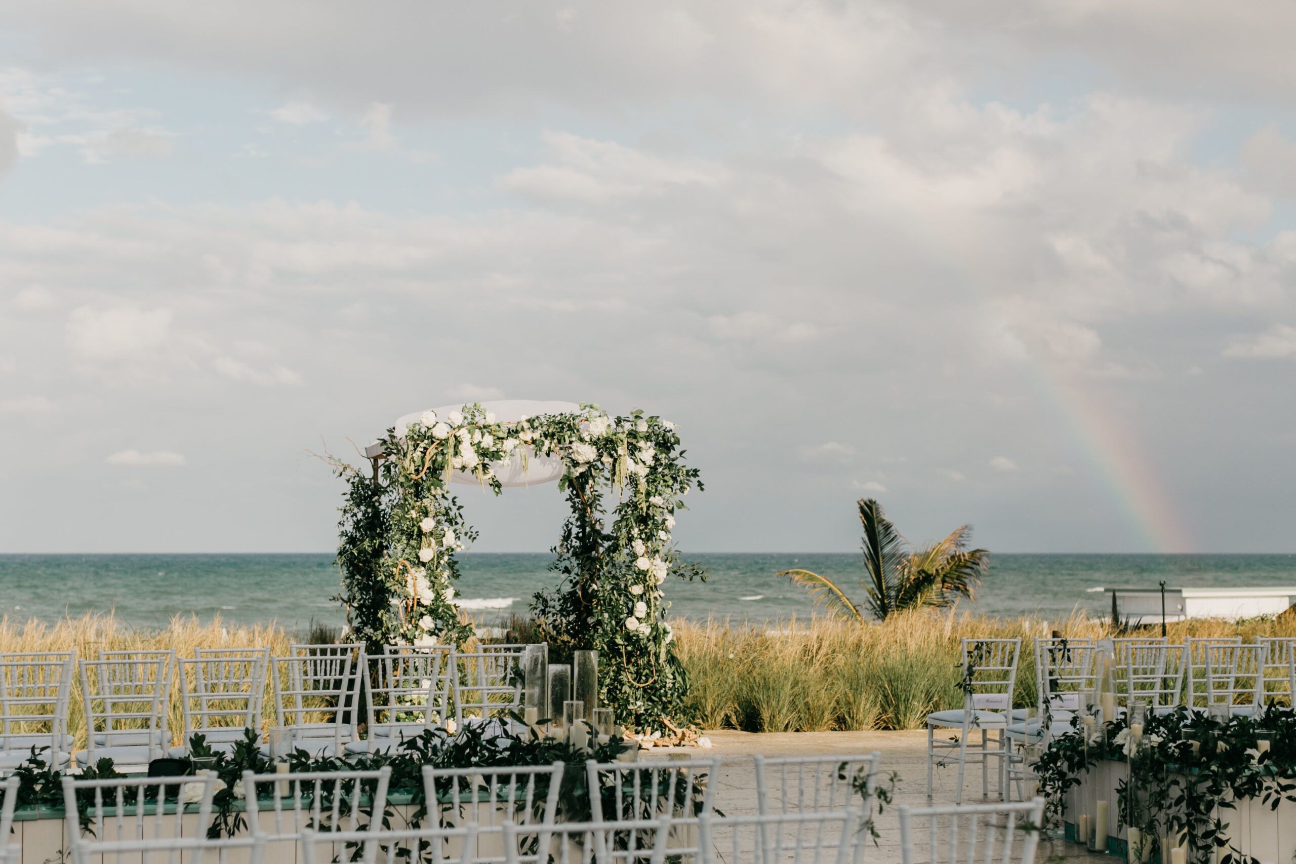 Wedding ceremony with white blooms and greenery on Pool Terrace at Four Seasons Resort Palm Beach