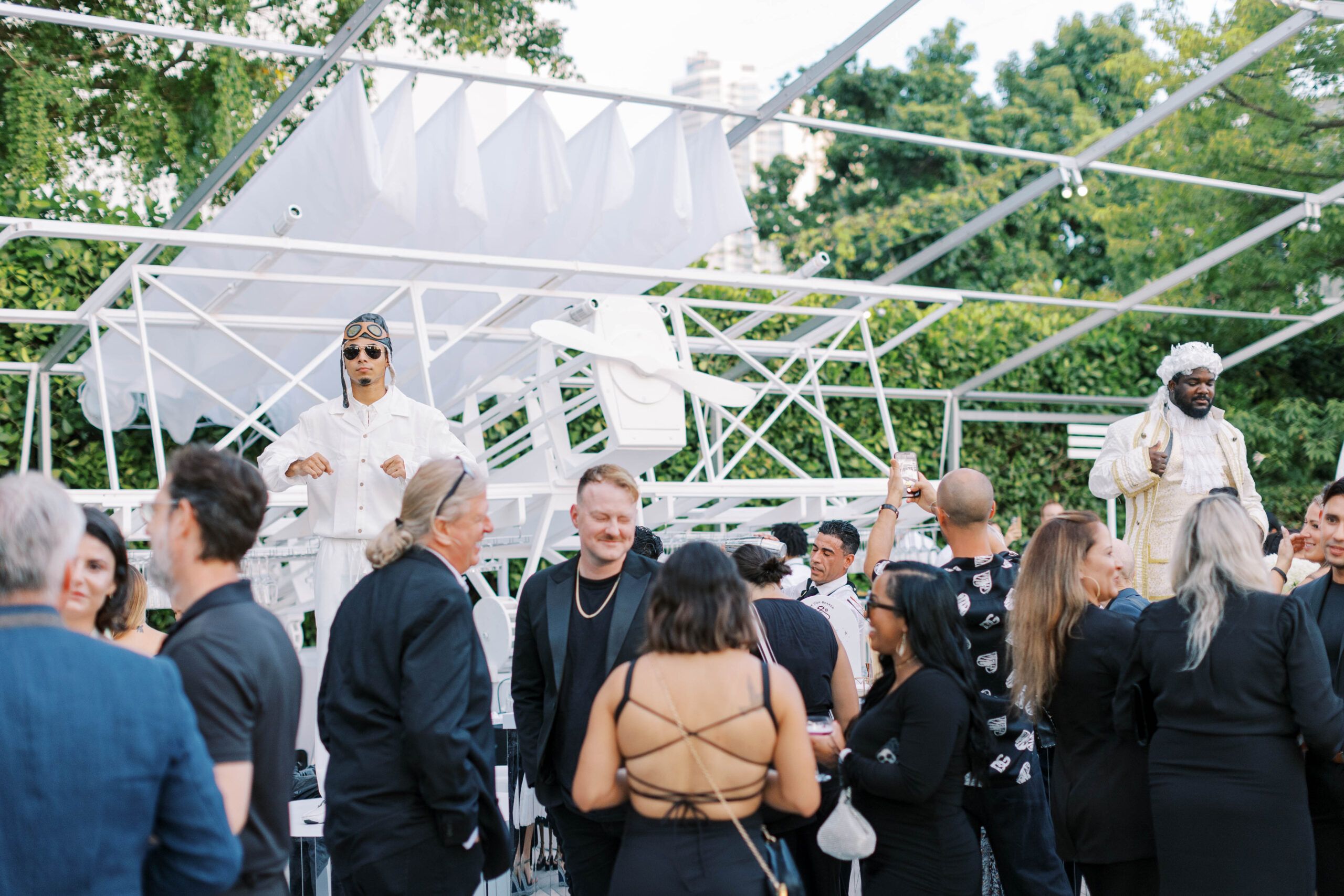 Guests surrounding the party at the outdoor party