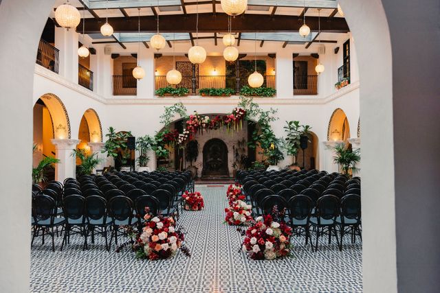 Featured photo from A Classic Miami Wedding Featuring Dramatic Red and Ivory Florals and a Grand Atrium Setting