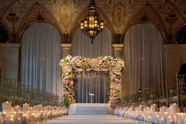 Featured photo from Whimsical Garden-Inspired Wedding at The Breakers with Candlelit Aisle and Floral Chuppah