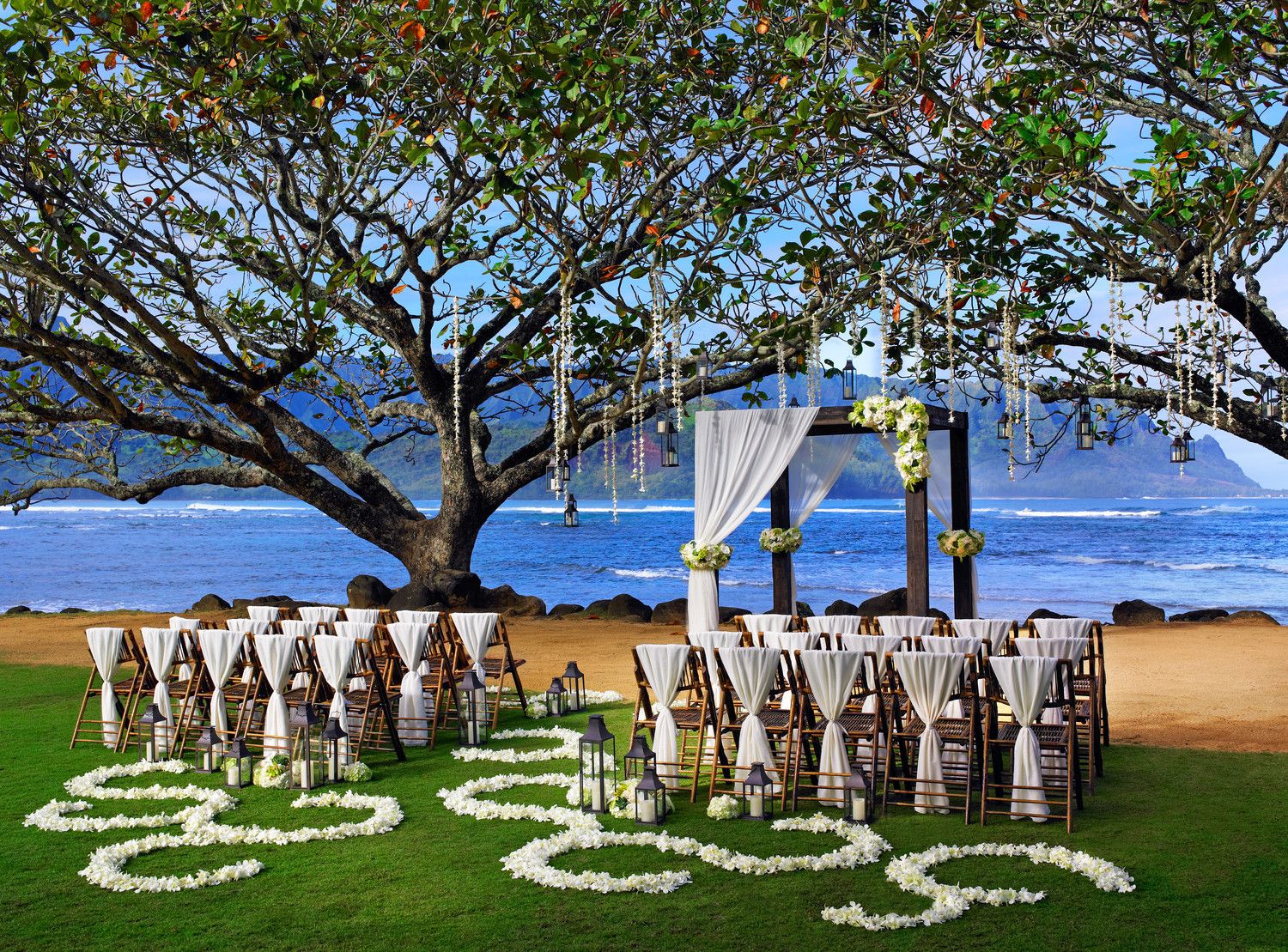 Kamani Cove Venue at 1 Hotel Hanalei Bay with intimate garden ceremony setup and lush tropical surroundings