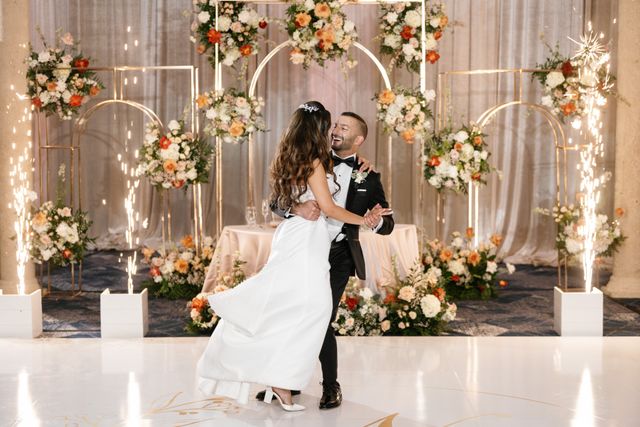 Featured photo from Witness This Elegant Bella Collina Wedding with Bloom-Filled Arch Backdrops and Sparkler Moments