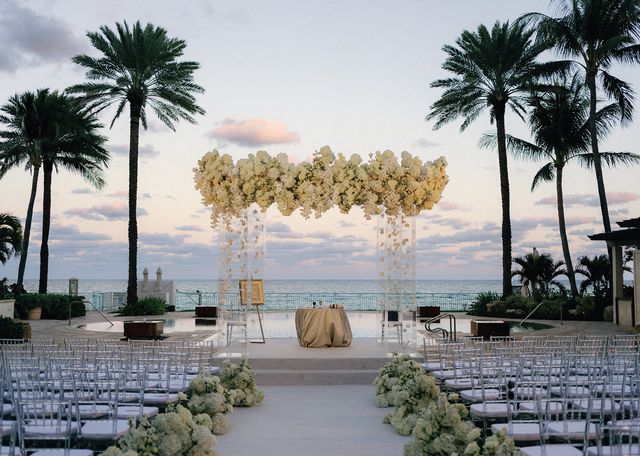 Featured photo from Experience This Oceanfront Wedding at a Luxury Palm Beach Resort Featuring Cascading White Florals
