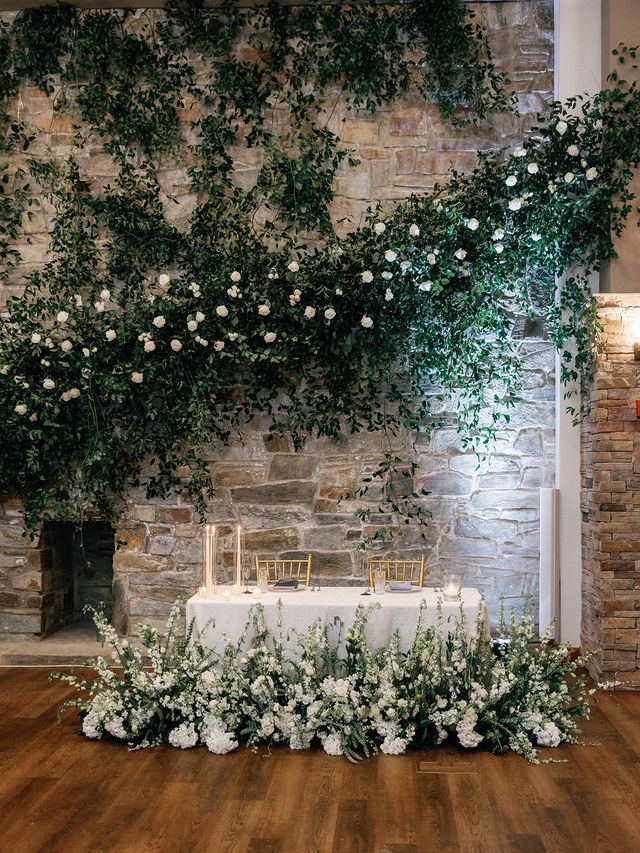 Featured photo from Elegant White & Green Winter Wedding with Floral Wall & Candlelit Reception
